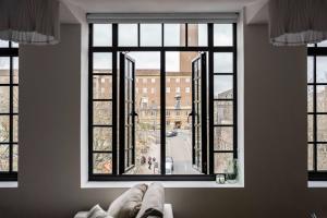 a room with a large window with a couch in front of it at Seven Space - The Old Post Office Court in Norwich