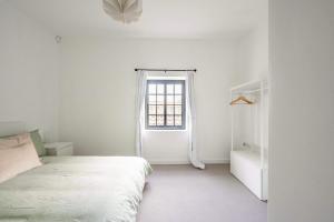 a white bedroom with a bed and a window at Seven Space - The Old Post Office Court in Norwich +27 photos