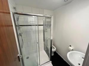 a bathroom with a shower and a toilet and a sink at Trivelles Liverpool in Liverpool