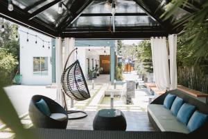 a living room with a couch and a swing at JJPHR Hotel San Antonio in Lubao