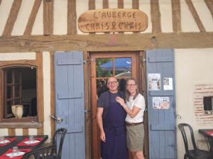 a man and a woman standing in front of a door at L'auberge Chris and Chris in Retjons