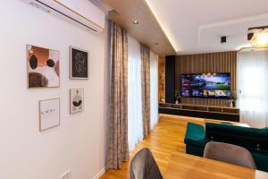 a living room with a couch and a television at Penthouse Petar in Kastel Stari