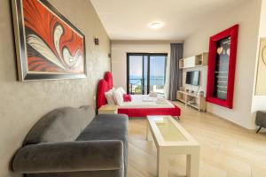 a living room with a couch and a bed at Britannia Resort & SPA in Vlorë