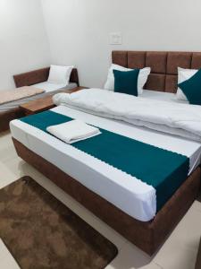 a bedroom with two beds and a couch at Uttarkashi Resort in Uttarkāshi