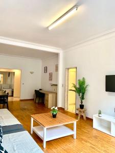a living room with a couch and a table at Belga Apartment 3 bedrooms. in Antwerp