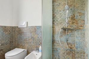 a bathroom with a shower with a toilet at Katy Lake Timo in Sirmione +21 photos