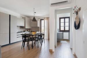 a kitchen and dining room with a table and chairs at Katy Lake Timo in Sirmione