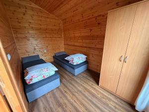 a small room with two beds and a cabinet at Willa Aleksander in Rewal