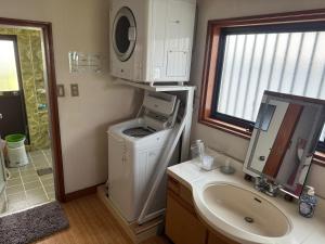 a bathroom with a washing machine and a sink at Kouan 功庵 in Matsuyama +36 photos