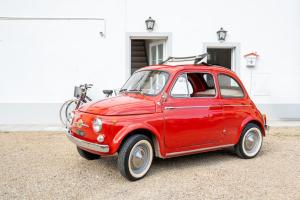 a small red car with a bike on top at casa stella a due passi dal centro in Arezzo