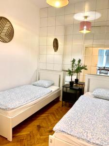 a bedroom with two beds and a table at Belga Apartment 3 bedrooms. in Antwerp