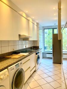 a kitchen with a washer and dryer at Belga Apartment 3 bedrooms. in Antwerp