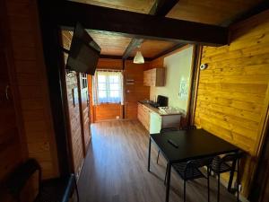a small kitchen with a table and chairs in a room at Domki na Wyspie Anna in Gdańsk