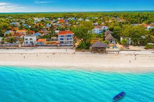 an aerial view of a beach with a resort at Uroa Beachfront Apt Direct Sand in Uroa