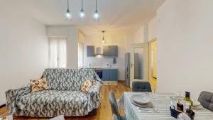 a living room with a couch and a table at [DolciAcque] Dolce sosta nel cuore di Acqui in Acqui Terme +14 photos