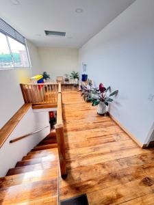 a living room with a staircase and wooden floors at Casa Real Circacia in Circasia