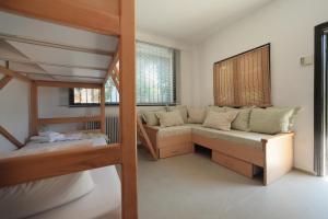 a bedroom with a bunk bed and a bed and a couch at River side house in Kastoria