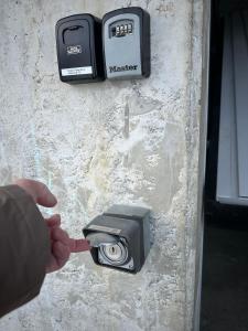 a person is pointing at a camera on a wall at Chalet Panorama in Adelboden