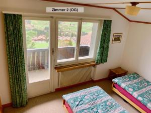 a room with a window and a bed and a window at Chalet Panorama in Adelboden