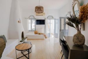 a living room with a couch and a table at Onar Hotel & Suites in Tinos