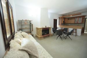 a living room with a couch and a fireplace at River side house in Kastoria