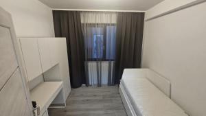 a small room with a couch and a window at Donath park view in Baciu