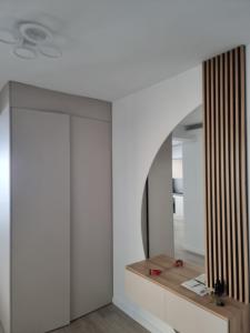 a room with white walls and a mirror at Donath park view in Baciu