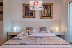 a bedroom with a bed with a table and two lamps at La Braveta in Sant Antoni de Calonge