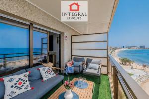 a balcony with a couch and a view of the beach at La Braveta in Sant Antoni de Calonge
