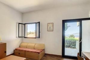 a living room with a couch and a window at Beautiful 40 M2 With Pool Near The Beach! in Grosseto-Prugna