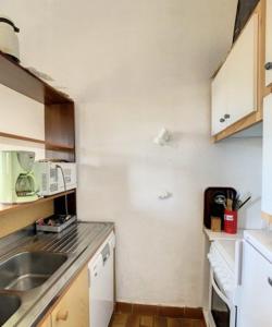a small kitchen with a sink and a counter at Beautiful 40 M2 With Pool Near The Beach! in Grosseto-Prugna