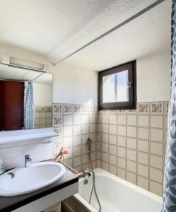 a bathroom with a sink and a bath tub at Beautiful 40 M2 With Pool Near The Beach! in Grosseto-Prugna