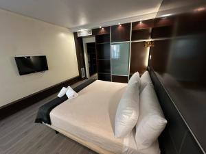 a hotel room with a bed and a flat screen tv at Puerta de Africa in Ceuta