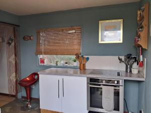 a kitchen with a counter and a stove and a window at The Old Waterworks - Venus Bell Tent in Clare