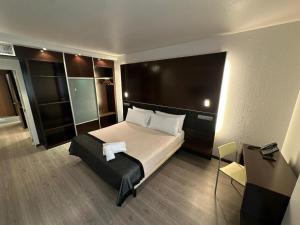 a bedroom with a large bed with a large headboard at Puerta de Africa in Ceuta
