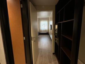 a hallway leading to a room with a window at Puerta de Africa in Ceuta +4 photos