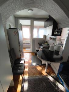 a kitchen with a table and a dining room at Топсоба12 in Niš