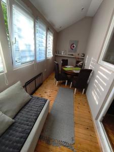 a living room with a bed and a table with chairs at Топсоба12 in Niš