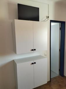 a white cabinet with a television on top of it at Residencia Laranjeira in Odeceixe +33 photos
