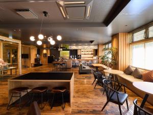 a restaurant with a bar with chairs and tables at mt. inn(マウントイン） in Nihommatsu