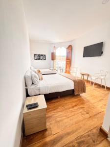 a bedroom with a large bed and a wooden floor at Casa Real Circacia in Circasia