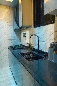 a kitchen with a sink and a counter top at Apartment60 in Lagos