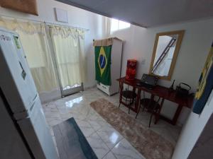 a room with a desk and a table with a mirror at Casa de Férias Carioca in Rio de Janeiro