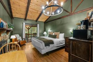 a bedroom with a bed and a tv in it at The Lost Compass in Sautee Nacoochee