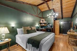 a bedroom with a large bed in a room with wooden ceilings at The Lost Compass in Sautee Nacoochee
