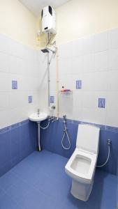 a blue and white bathroom with a toilet and a sink at The Villa Mahogany in Trivandrum +31 photos