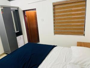 a bedroom with a white bed and a window at CHRIS COZY FARM cottage in Wayanad