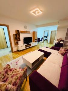 a living room with a couch and a table at Apartman Lala in Sarajevo