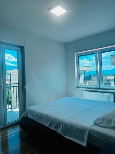 a bedroom with a bed with a blue light at Apartman Lala in Sarajevo