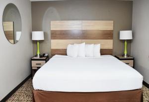 a hotel room with a large bed and two lamps at Baymont Inn And Suites by Wyndham Platteville in Platteville +105 photos